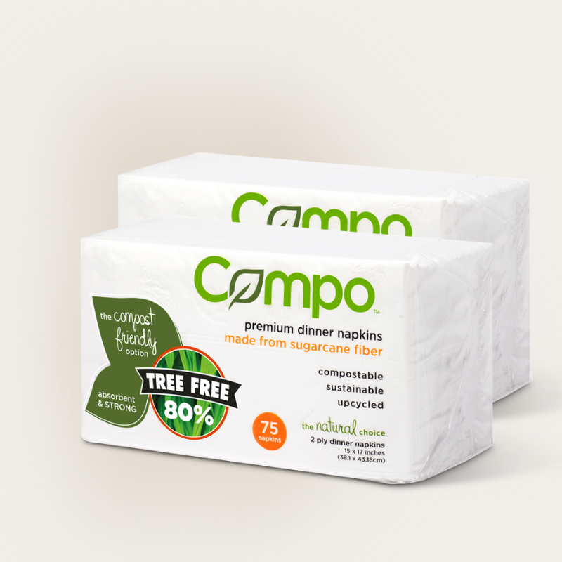 two packs of Compo premium dinner napkins on a light background